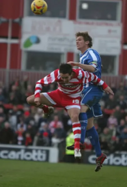 Buy Dean Hammond wins the ball in the air against Brian Stock