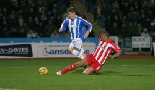 Buy Alex Revell is fouled by Gavin Caines to win a last-minute penalty
