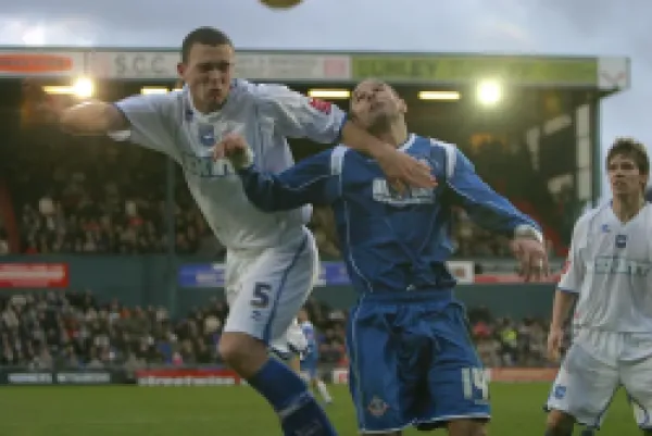 Buy Joel Lynch beats Oldham's Paul Warne to a header