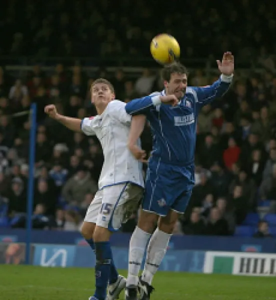 Buy Alex Revell in an aerial challenge with Oldham's Sean Gregan
