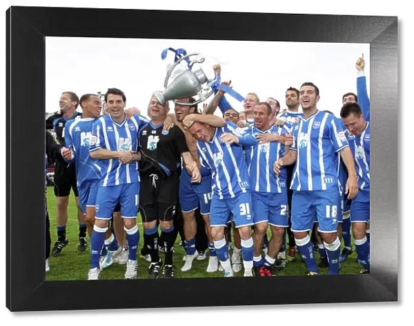 The players celebrate winning the League 1 title away at Walsall, April 2011