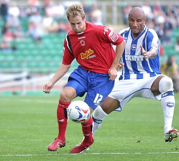 George Santos. battling for the ball with a Crewe player