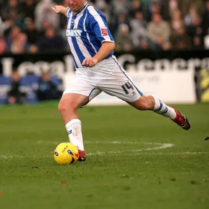 Brighton Midfielder Guy Butters Prepares to Strike the Ball