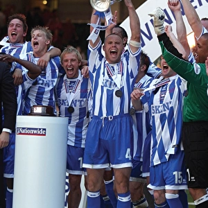 Danny Cullip lifts the play-off trophy at the Milennium Stadium, Cardiff