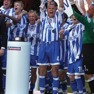 Danny Cullip lifts the play-off trophy at the Milennium Stadium, Cardiff