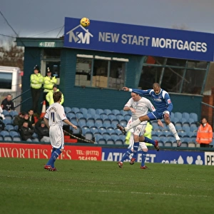 Guy Butters wins a header against Oldhams Chris Hall
