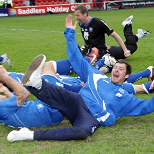 The players celebrate winning the League 1 title away at Walsall, April 2011