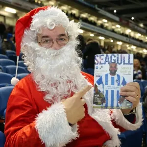 Santa's Invasion: Brighton and Hove Albion vs. Millwall Fans in Festive Costumes (12DEC14)