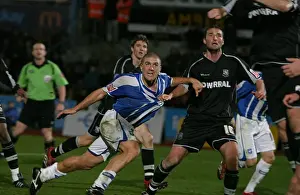 Adam El-Abd has his shirt pulled by Chris McCready in the penalty area