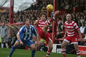 Images Dated 27th November 2006: Alex Revell watches Graeme Lee clear the ball