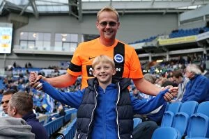Images Dated 25th October 2014: Brighton and Hove Albion Fans in Full Swing at American Express Community Stadium during SkyBet