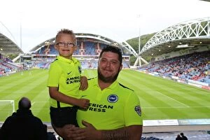 Images Dated 18th August 2015: Brighton and Hove Albion Fans in Full Swing at Huddersfield Town Championship Clash, August 2015