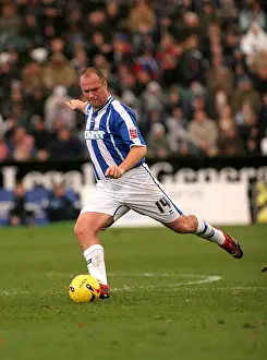 Brighton Midfielder Guy Butters Prepares to Strike the Ball