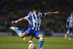 Images Dated 14th April 2015: Brighton Midfielder Joao Carlos Teixeira Fires a Shot Against Huddersfield Town