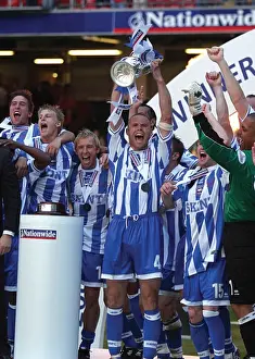 Danny Cullip lifts the play-off trophy at the Milennium Stadium, Cardiff