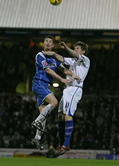 Dean Hammond challenges Oldhams Gary MacDonald in the air
