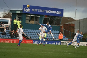 Images Dated 18th December 2006: Guy Butters wins a header against Oldhams Chris Hall