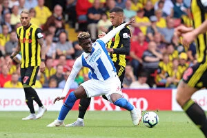 Images Dated 11th August 2018: Intense Midfield Showdown: Bissouma vs. Capoue in the Premier League Battle between Watford