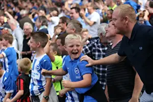Celebratory Prints: Jubilant Brighton Fans Celebrate Championship Victory at Craven Cottage (Fulham vs)