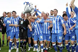 The players celebrate winning the League 1 title away at Walsall, April 2011